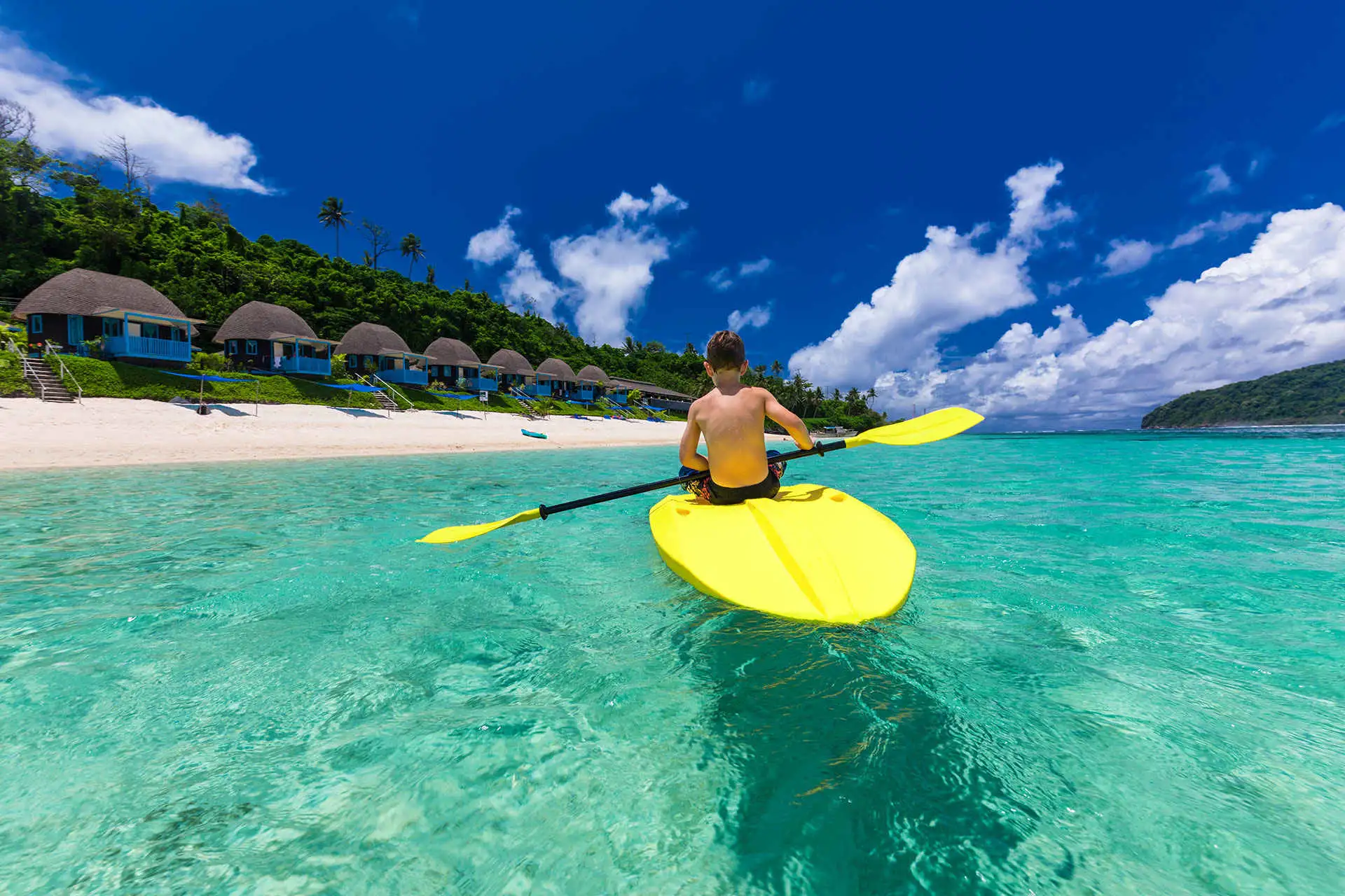 Boy Paddleboards in Fiji