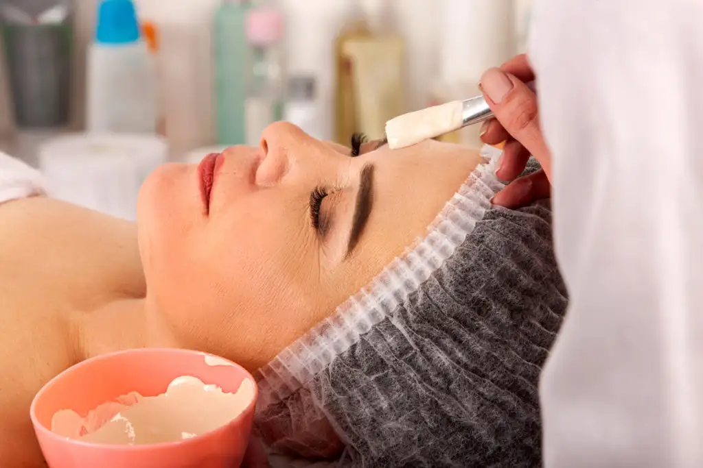 Older woman receiving a facial treatment at a spa