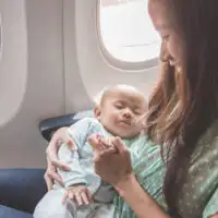 baby sleeping on plane; Courtesy of Odua Images / Shutterstock