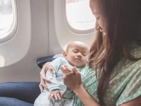 baby sleeping on plane; Courtesy of Odua Images / Shutterstock