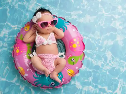 Infant Floating in Pool Wearing Sunglasses; Courtesy of Katrina Elena/Shutterstock.com