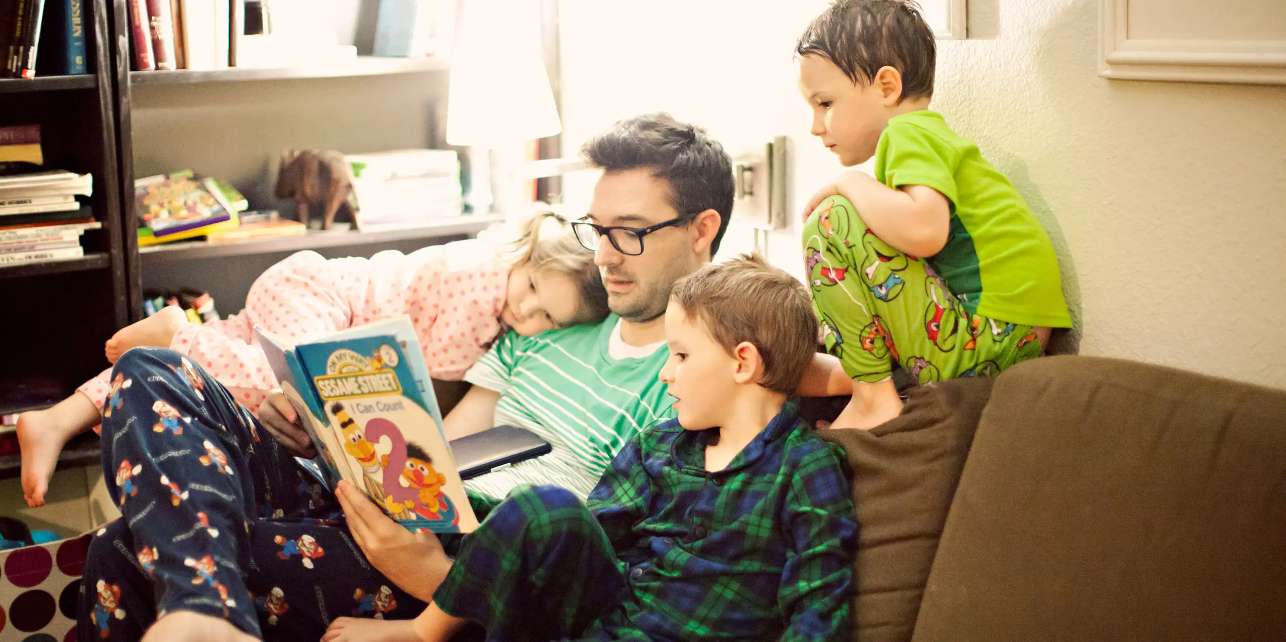 Dad Reading Bedtime Stories to Kids