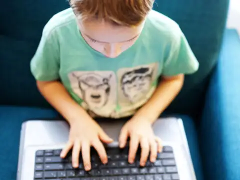 Boy playing on laptop; Courtesy of Twenty20