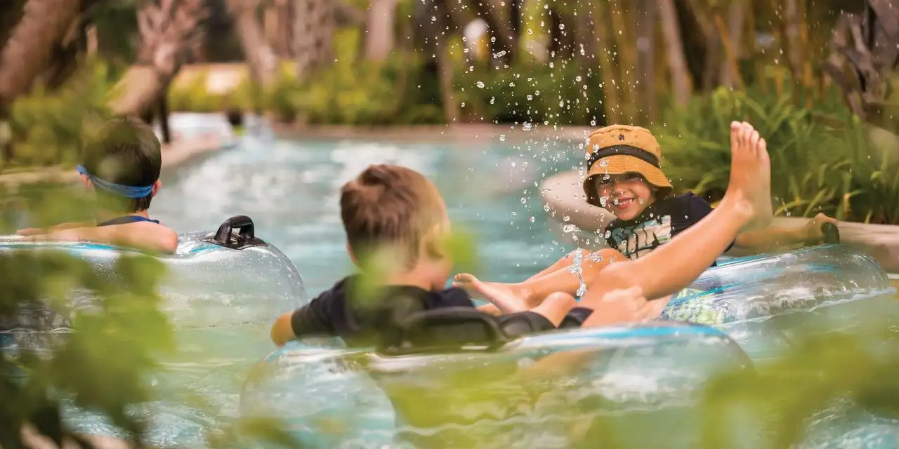 Young Boys Floating in Lazy River at Four Seasons Resort Orlando at Walt Disney World Resort; Courtesy of Four Seasons Resort Orlando at Walt Disney World Resort