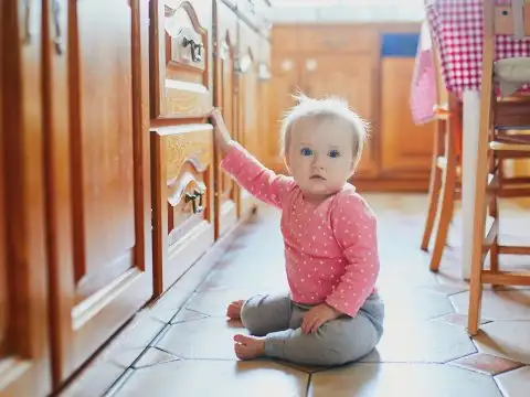 Toddler on Floor in Kitchen; Courtesy of Ekaterina Pokrovsky/Shutterstock.com