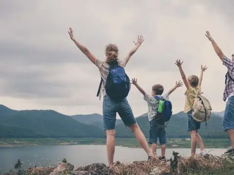 Family hiking with backpacks; Courtesy of altanaka/Shutterstock.com