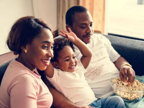 Family Watching Movie with Popcorn