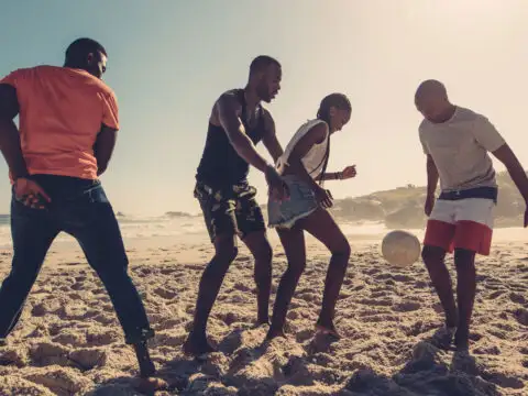 Family Playing Beach Game; Courtesy of Jacob Lund/Shutterstock.com