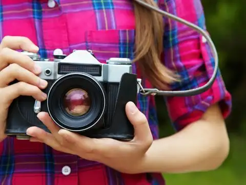 Girl with a Camera; Courtesy of Evgeny Bakharev/Shutterstock.com