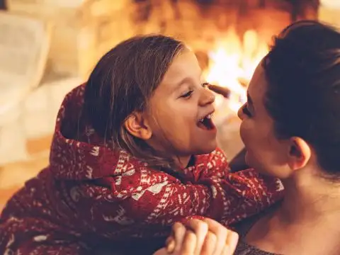 Mom and Daughter in Cozy Cabin; Courtesy ofAlena Ozerova/Shutterstock.com