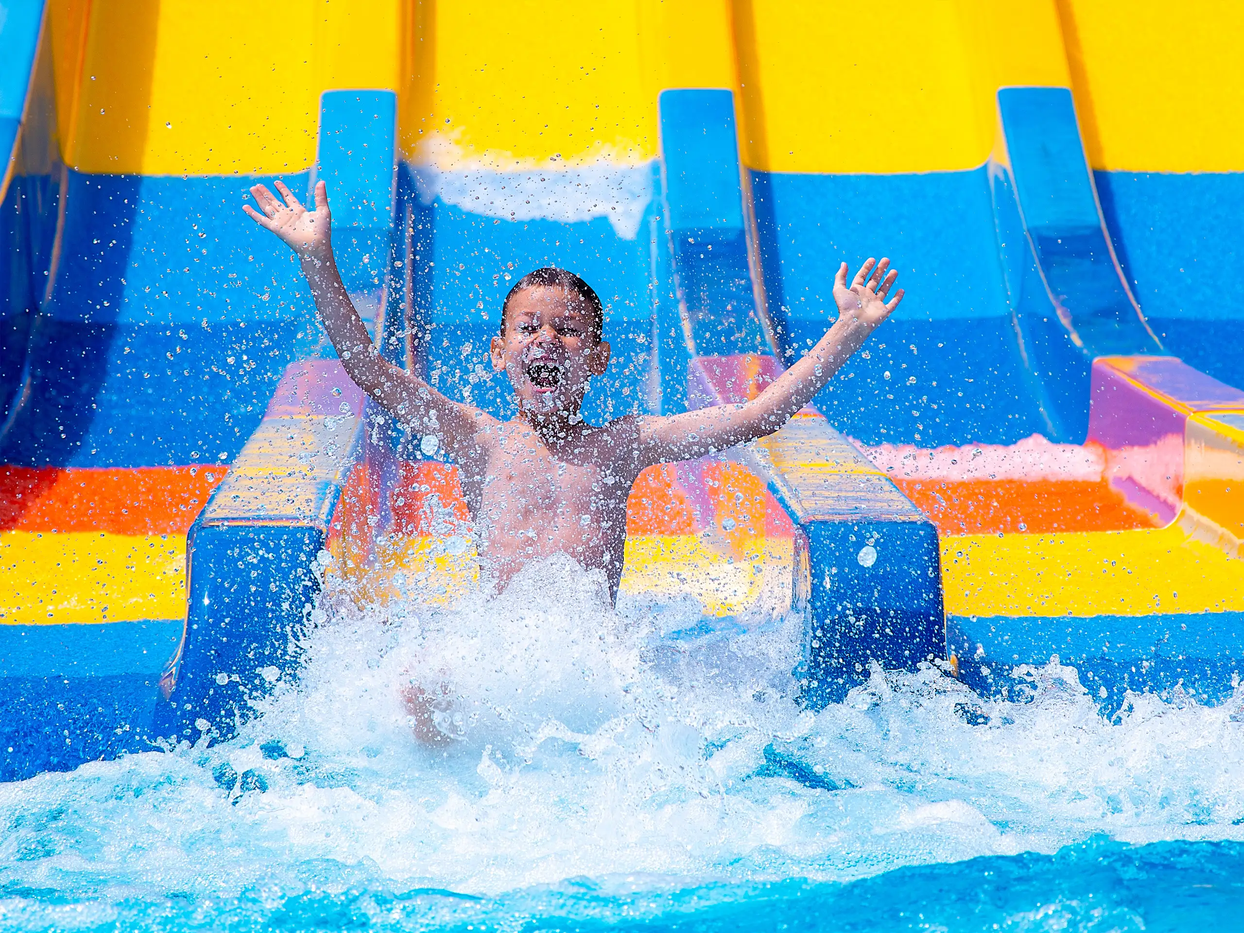 child going down water slide