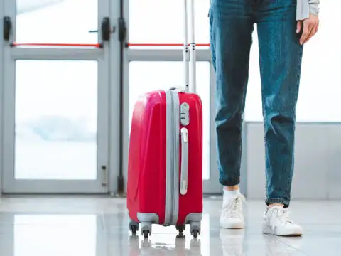 Woman Wearing Boyfriend Jeans at Airport; Courtesy of LightField Studios/Shutterstock.com